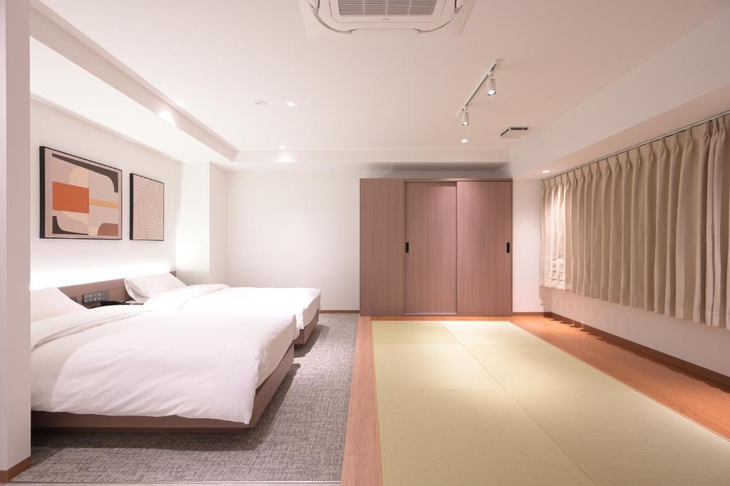 Postel nebo postele na pokoji v ubytování COCOYO Hotel 大塚
