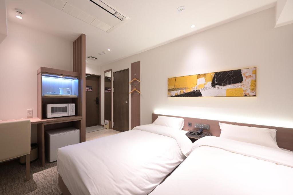 Postel nebo postele na pokoji v ubytování COCOYO Hotel 大塚