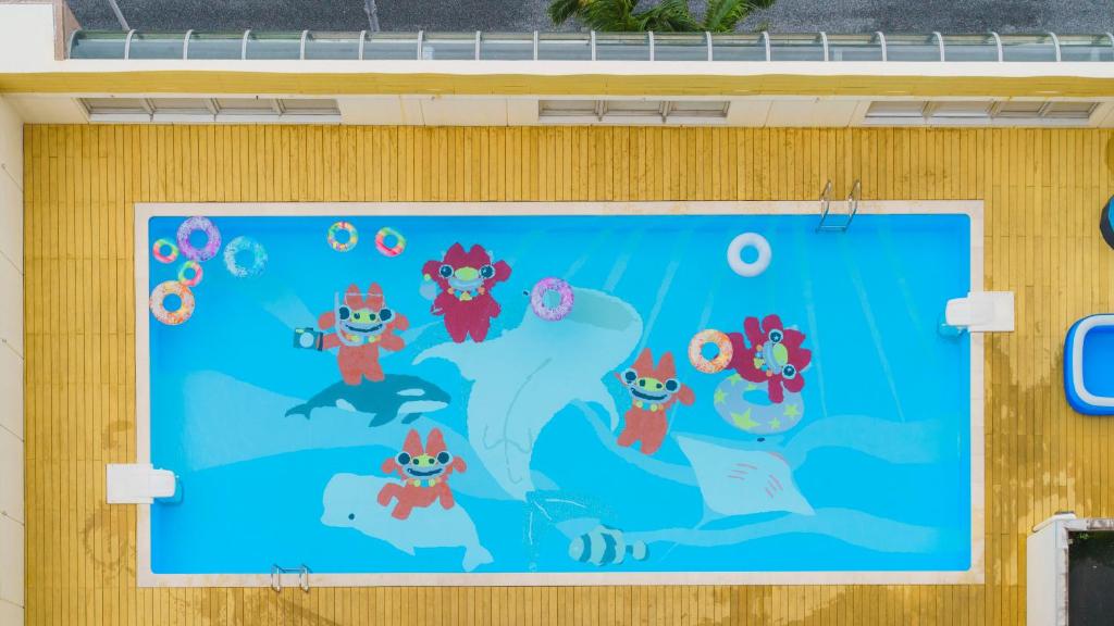 a mural on the side of a swimming pool at Hotel Ocean (Kokusai-Dori) in Naha