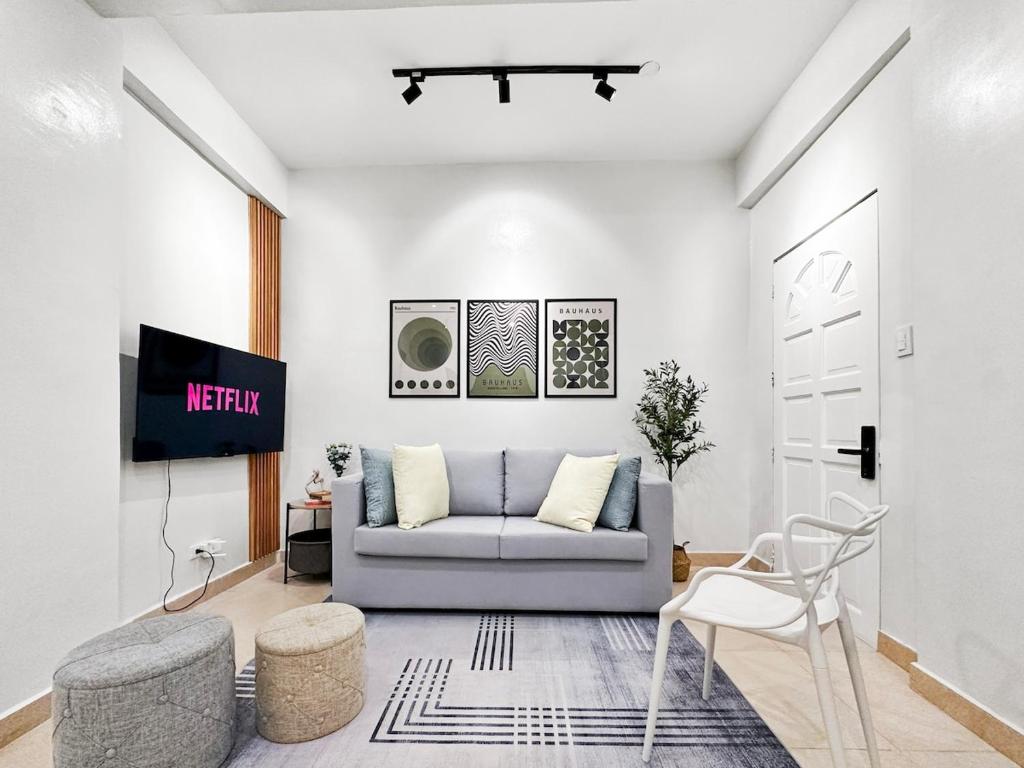 a living room with a couch and a tv at Family Apartment By The Beach with Kitchen Netflix Station 3 Beachfront in Boracay