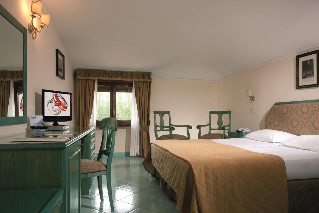 Posteľ alebo postele v izbe v ubytovaní Hotel Iaccarino