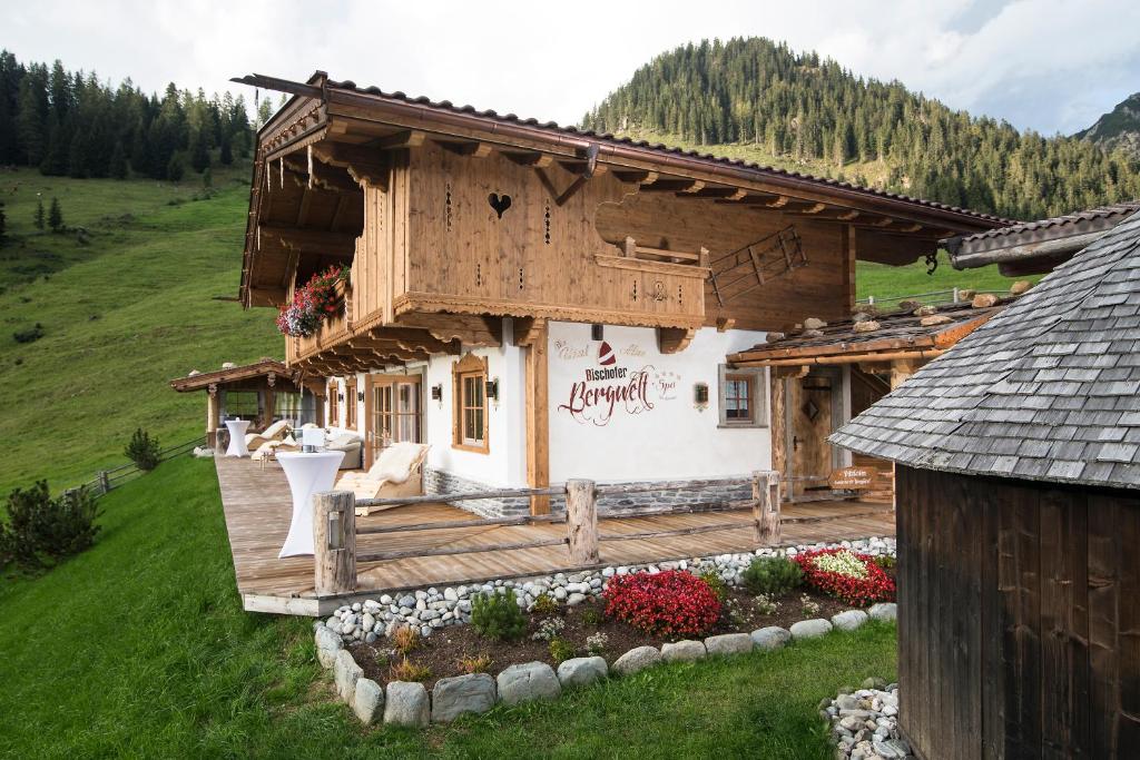a small house with a deck in a field at Romantiksuite in Alpbach