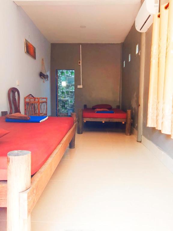 a bedroom with two beds and a red mattress at Lazy Bones in Koh Rong Sanloem