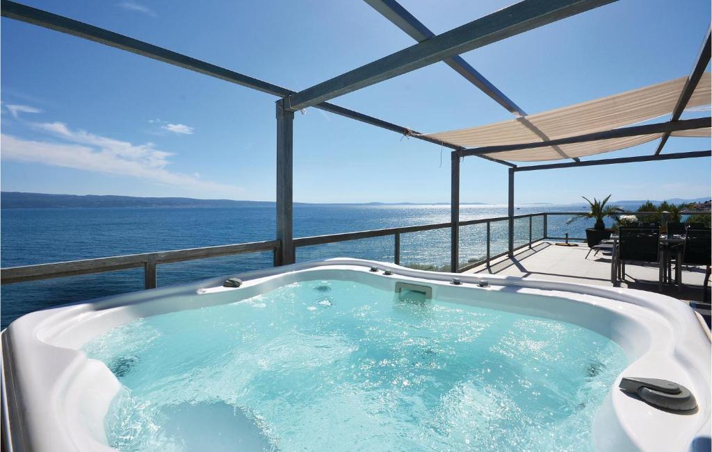 a jacuzzi tub with a view of the ocean at Apartment Krilo Jesenice 24 in Jesenice