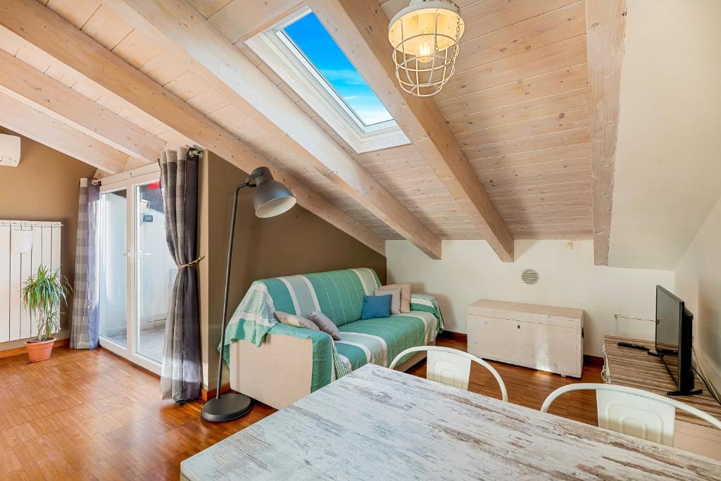 a living room with a couch and a table at Loft&Sun in La Spezia