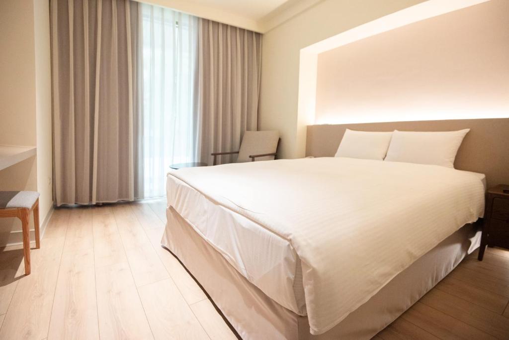 Postel nebo postele na pokoji v ubytování Hotel Tainan