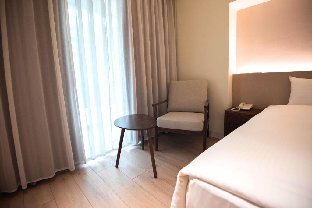 Postel nebo postele na pokoji v ubytování Hotel Tainan