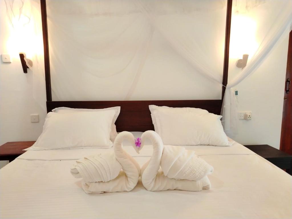 Postel nebo postele na pokoji v ubytování White Villa - Homestay