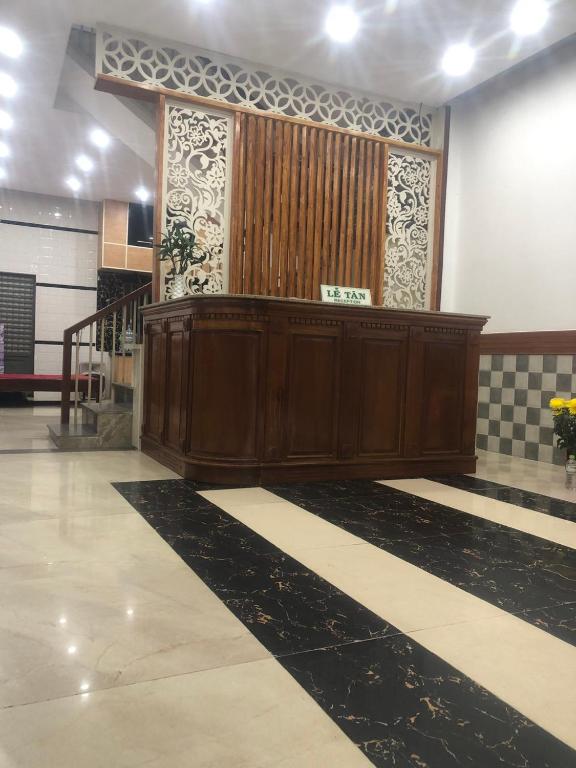 a wooden podium in a room with a staircase at Thuật Nguyễn Hotel in Da Nang