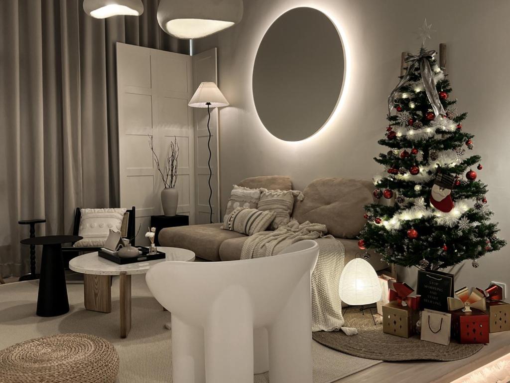 a living room with a christmas tree and a couch at Cozy Ins Duplex EkoCheras 1-6pax in Kuala Lumpur