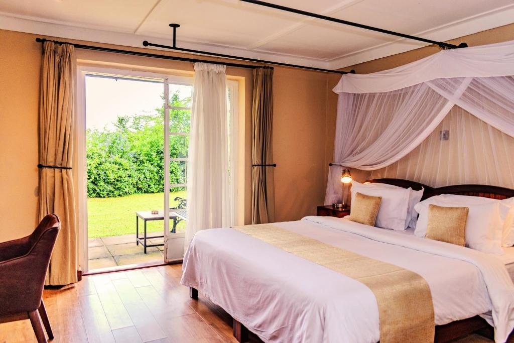 a bedroom with a large bed and a large window at Aero Club of East Africa in Nairobi