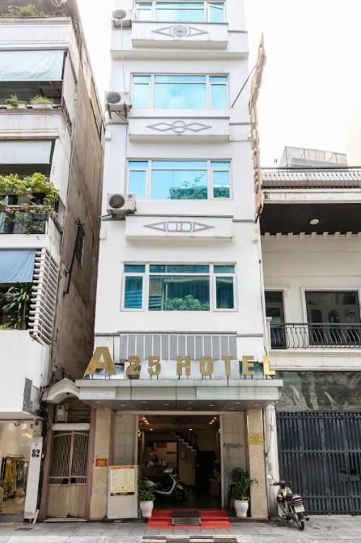 a tall white building with a sign on it at A25 Hotel - 80 Mai Hắc Đế in Hanoi