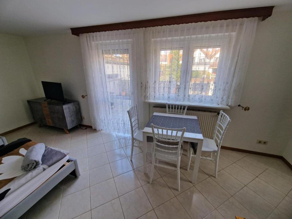 a dining room with a table and chairs and a couch at Wohnung - Goldene Gerste in Frankfurt/Main