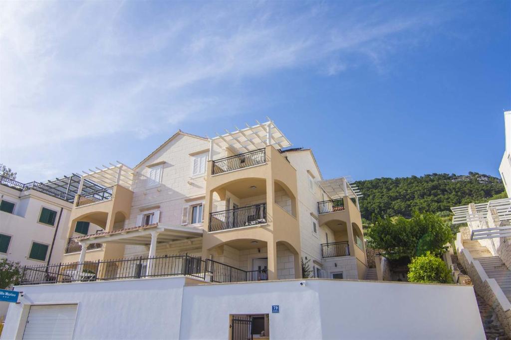 a large building with balconies on the side of it at Villa Marina Bol in Bol