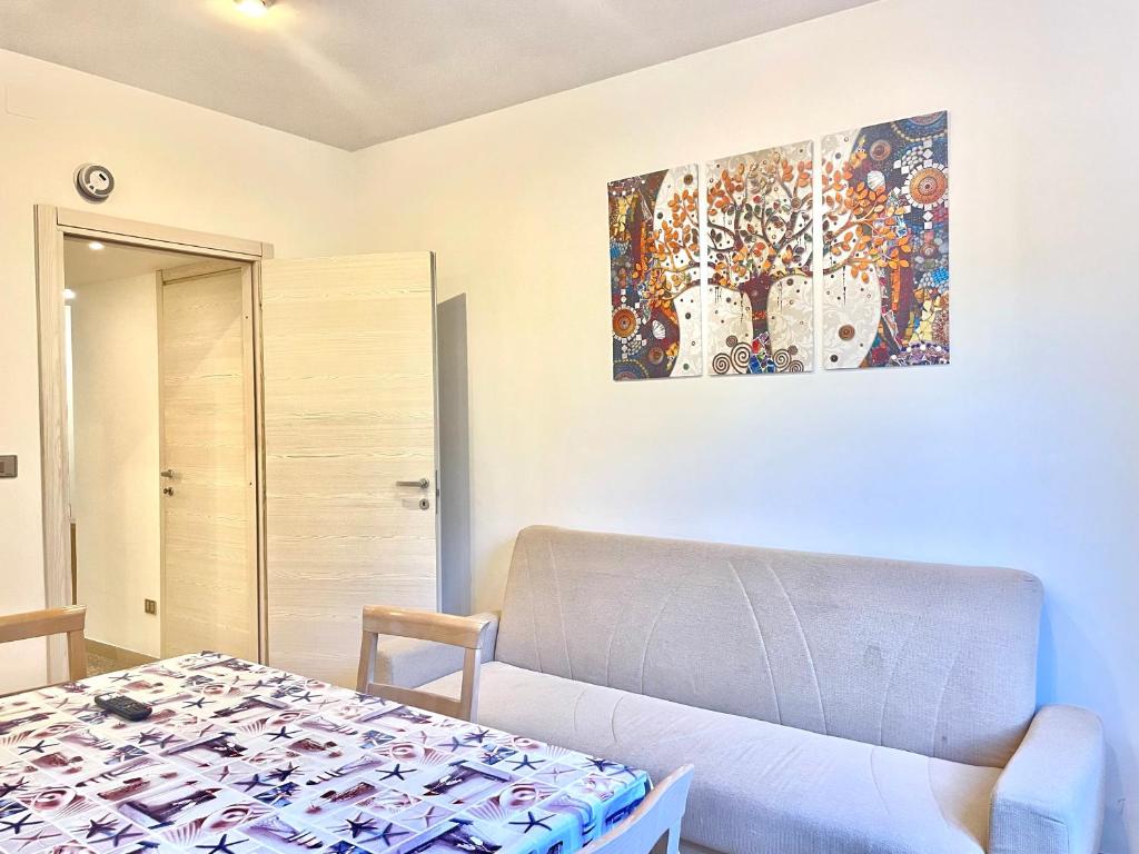 a living room with a couch and a painting on the wall at GRAMSCI HOUSE - Anzio Centro in Anzio