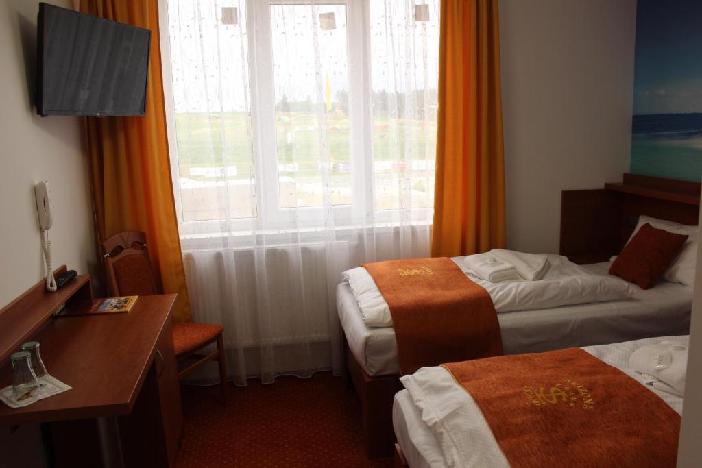 Postel nebo postele na pokoji v ubytování Hotelový resort Šikland
