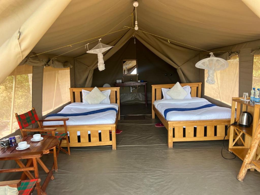 Postel nebo postele na pokoji v ubytování Sunset Masai Camp