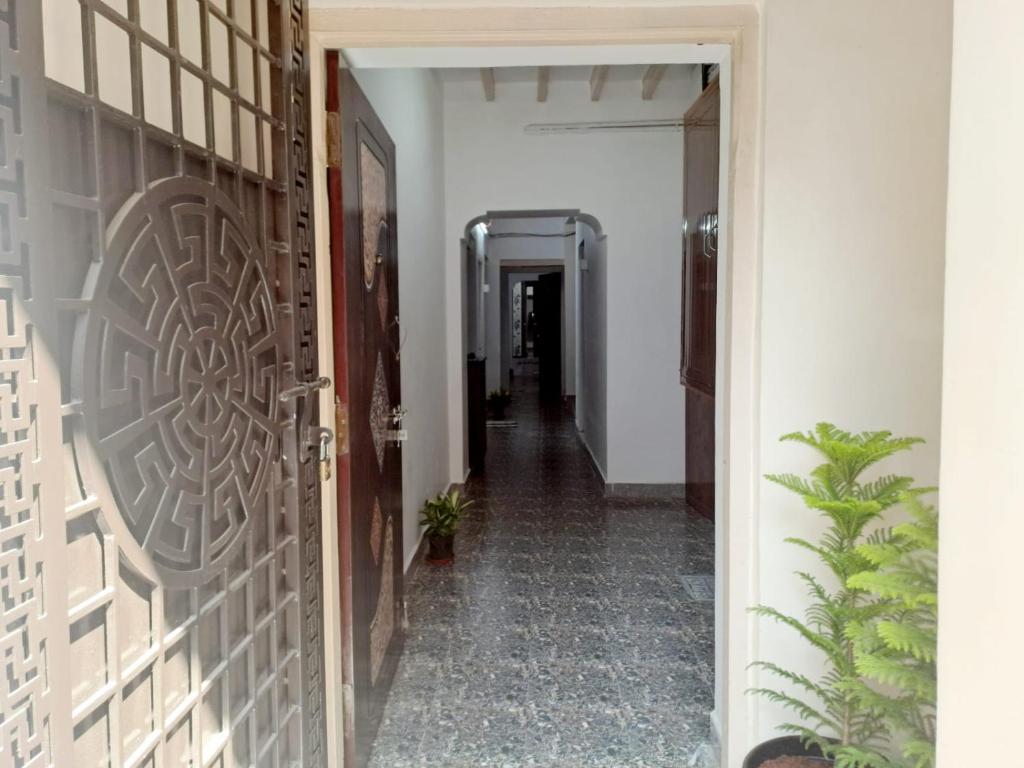a hallway with a door leading into a room at Airport PickupBeachChepauk StadiumKitchenWIFI in Chennai