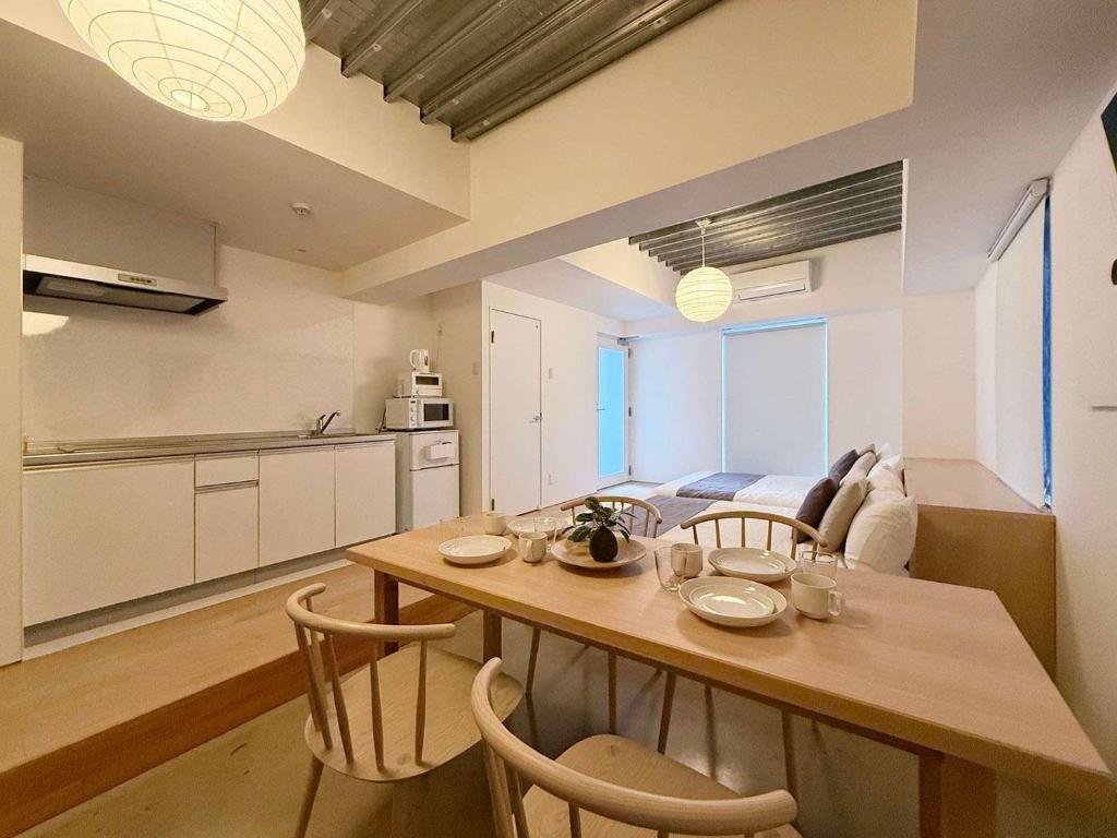 a kitchen and dining room with a table and chairs at bHOTEL Arts Dobashi - Beautiful Apt in the Heart of the City in Hiroshima
