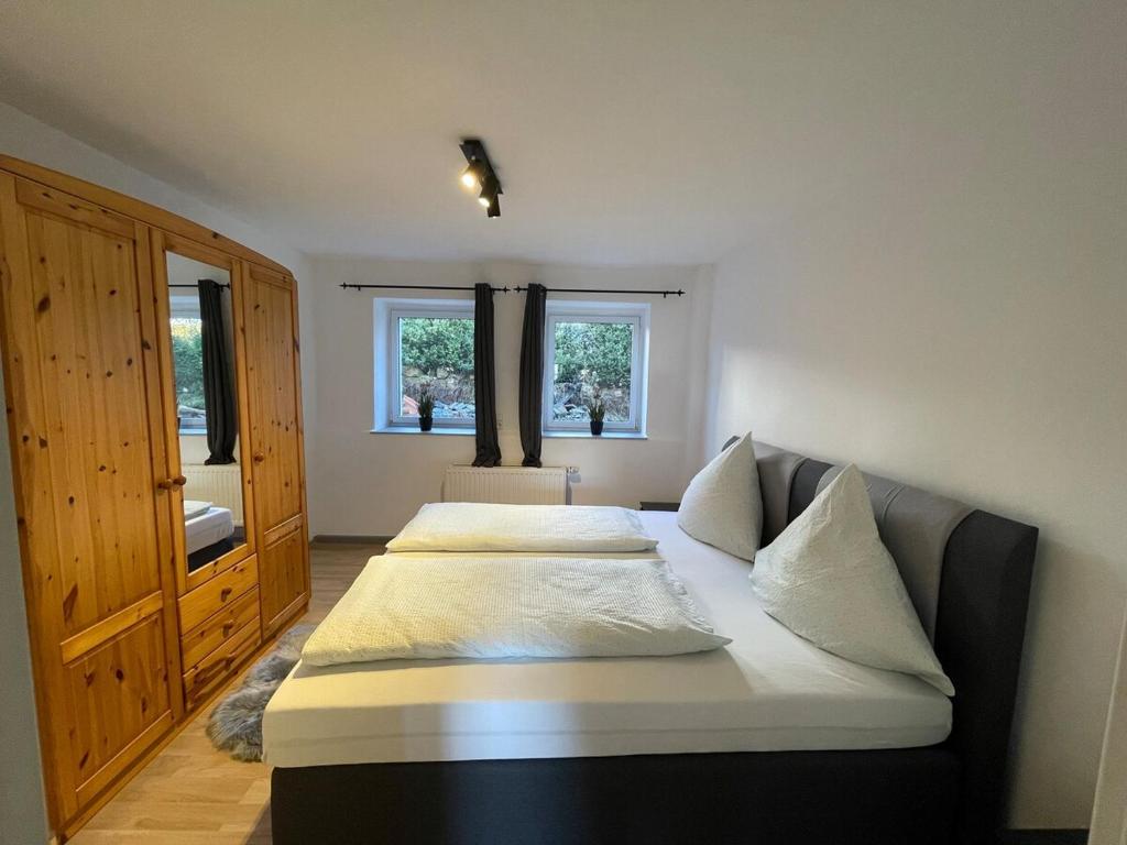 two beds in a room with two windows at Ferienhaus - Eifeltraum - Salm in Salm