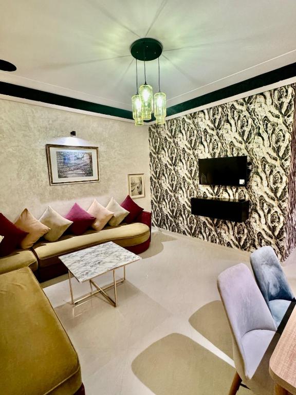 a living room with a couch and a table at Apartment, well equipped in Fez