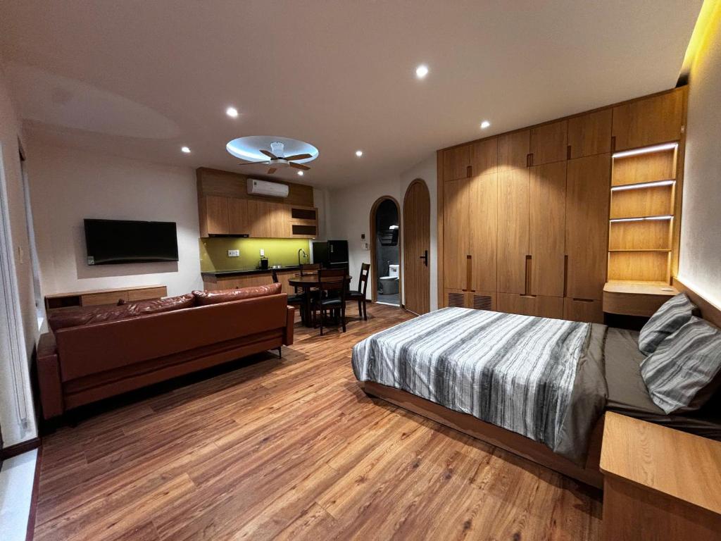 a bedroom with a bed and a living room at Wabi Homes in Buon Ma Thuot