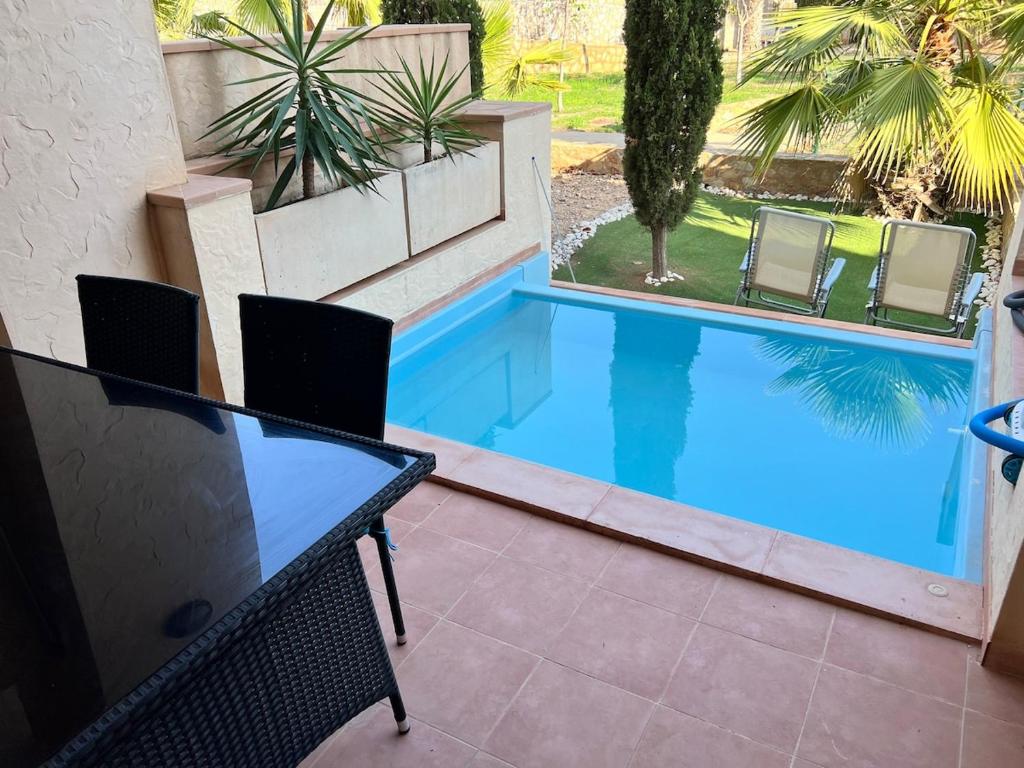 a swimming pool with a table and chairs in a yard at Oasis Paradise 4A in Corverica