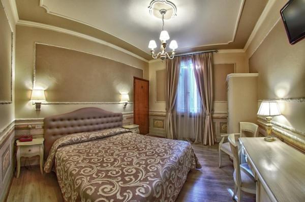 Postel nebo postele na pokoji v ubytování Hotel Pedrini
