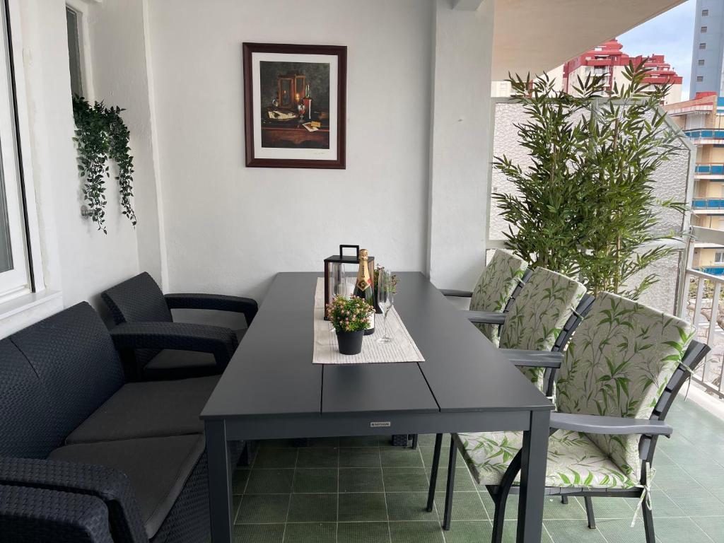 a black dining table and chairs in a room at SOLMAR Playa Gandia SOLO FAMILIAS in Playa de Gandia