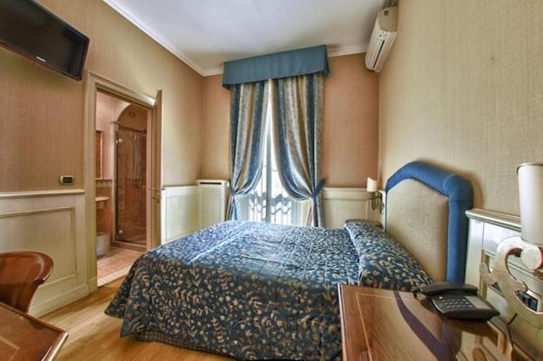 Postel nebo postele na pokoji v ubytování Hotel Pedrini