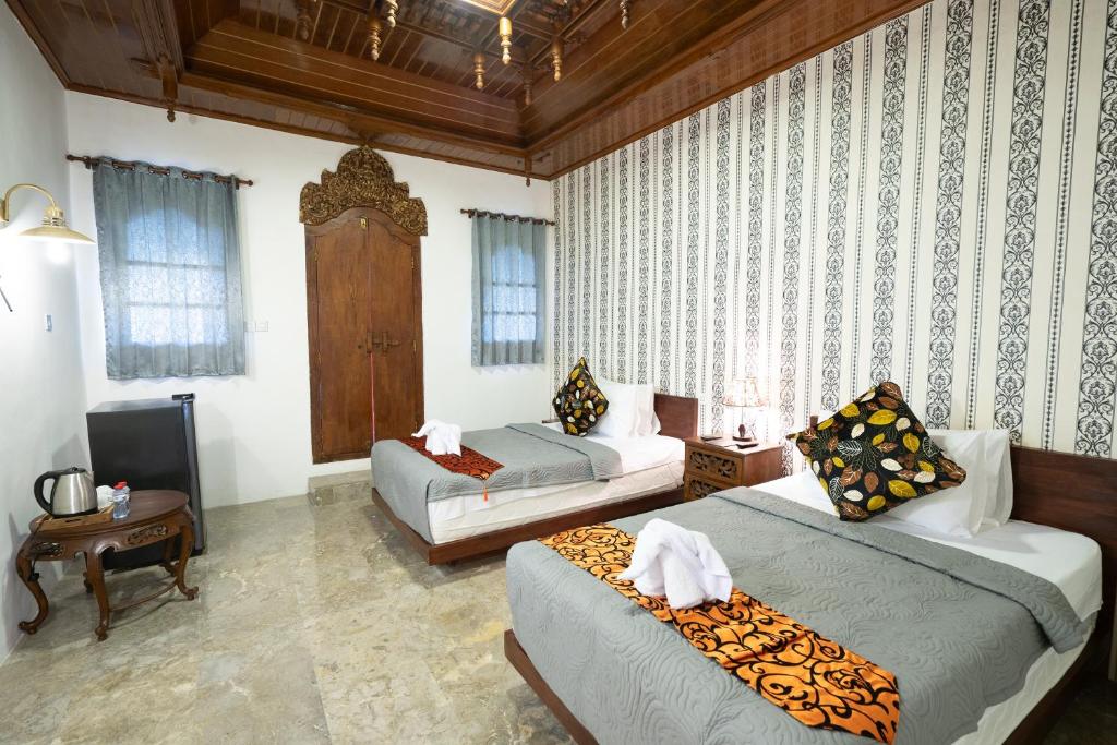 Postel nebo postele na pokoji v ubytování The Saharah Mirage Bali