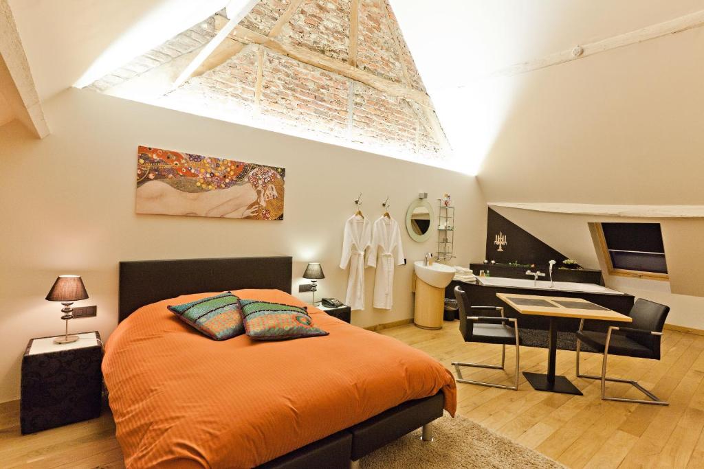 Postel nebo postele na pokoji v ubytování De Verborgen Parel B&B