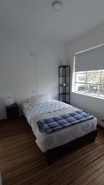 Postel nebo postele na pokoji v ubytování Casa Yolo Bogotá