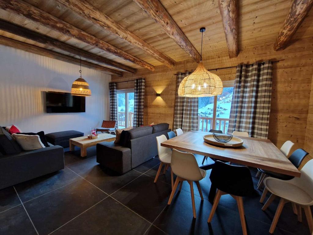 a living room with a table and a couch at Chalet 4 chambres, confort moderne, Arêches-Beaufort - FR-1-342-331 in Beaufort