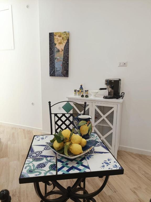 a table with a plate of fruit on it at B&B DieMme Amalfi Coast in Vietri sul Mare