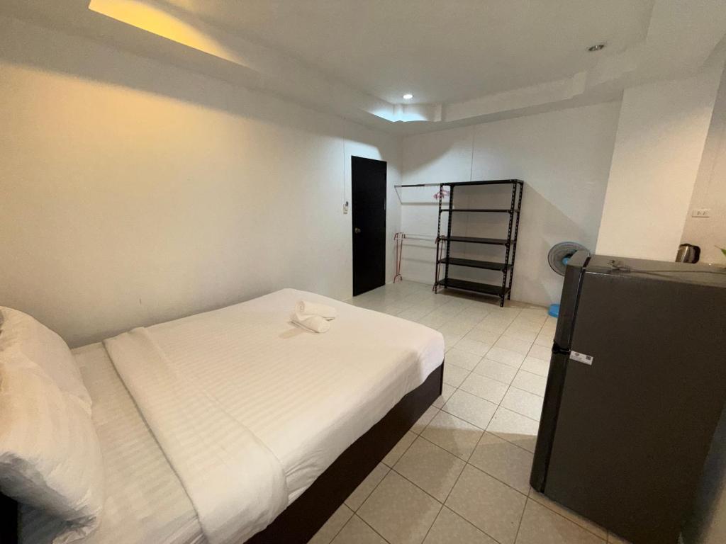 a small bedroom with a bed and a ladder in it at Patong Canal Villa 101 in Patong Beach