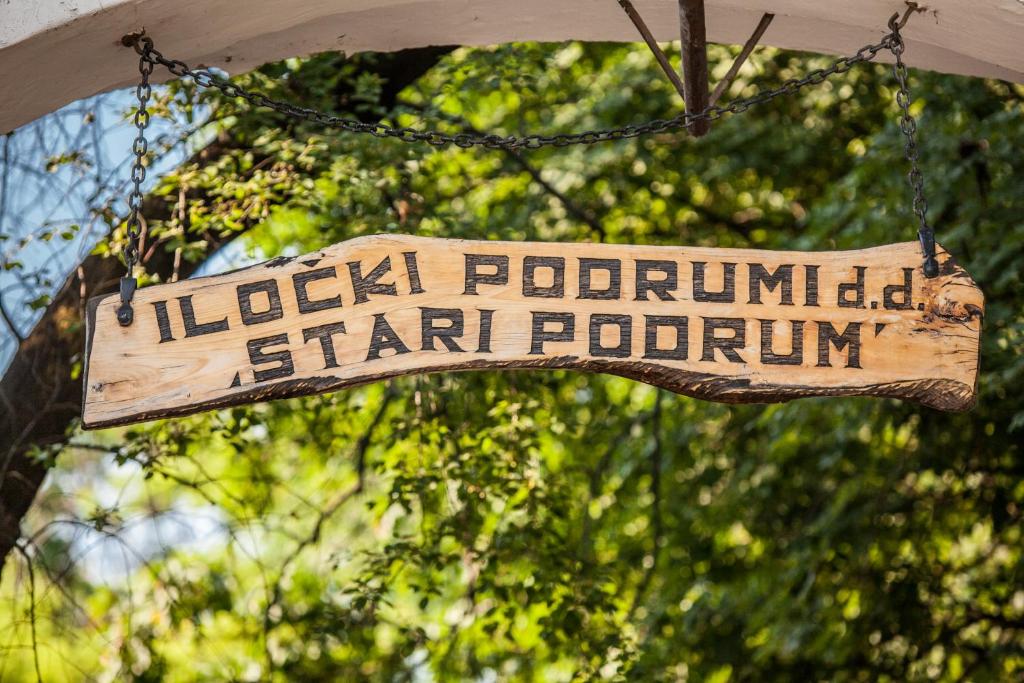 a wooden sign that reads local portland starpotuation at Hotel Stari Podrum in Ilok
