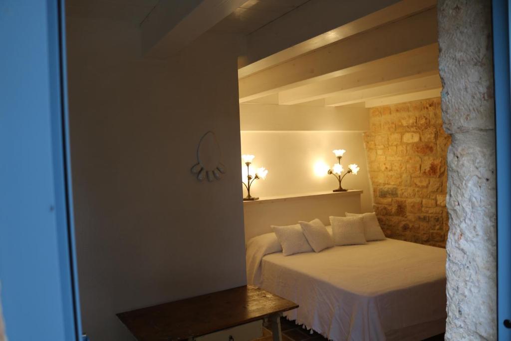 Postel nebo postele na pokoji v ubytování Trulli alla Controra