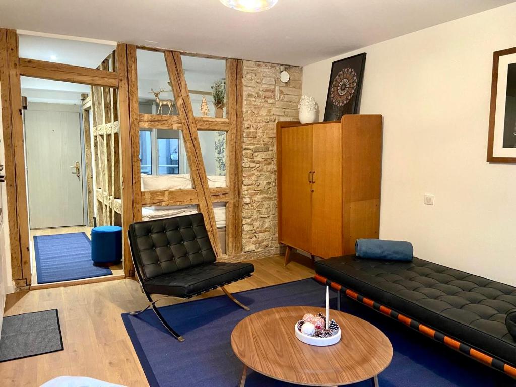 Hotel Studio Cathédrale, a living room with a couch and a table at Studio Cathédrale in Strasbourg