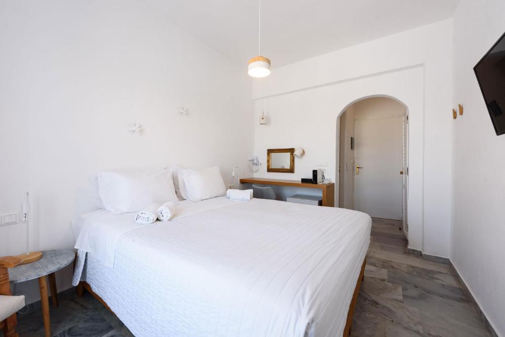 Postel nebo postele na pokoji v ubytování Vounali Rooms