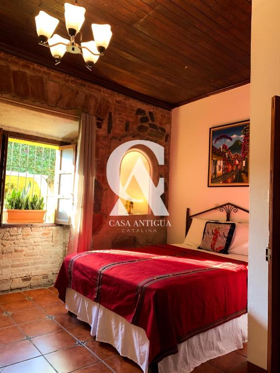 a bedroom with a red bed in a room at Casa Altavista in Antigua Guatemala
