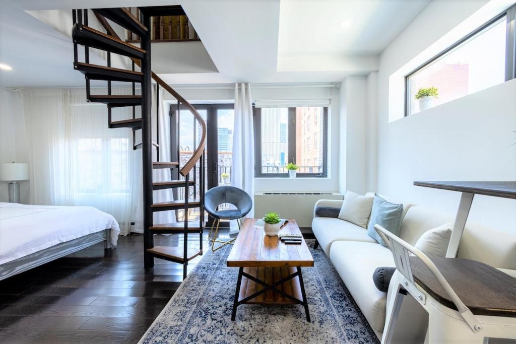 a living room with a loft bed and a couch at 809-6B New 2BR Duplex With Private Patio in New York