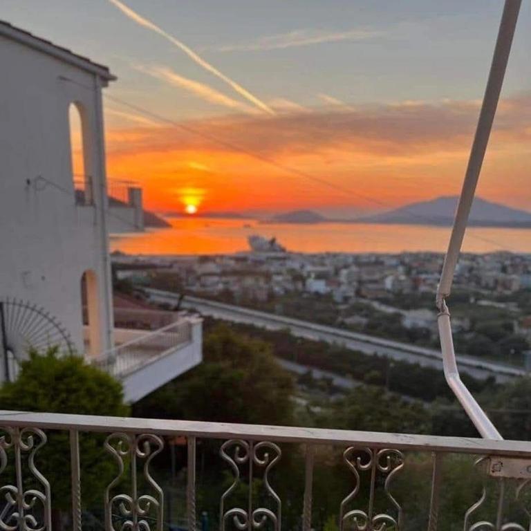 a view of the sunset from a balcony of a building at Villa Butterfly Igoumenitsa in Igoumenitsa