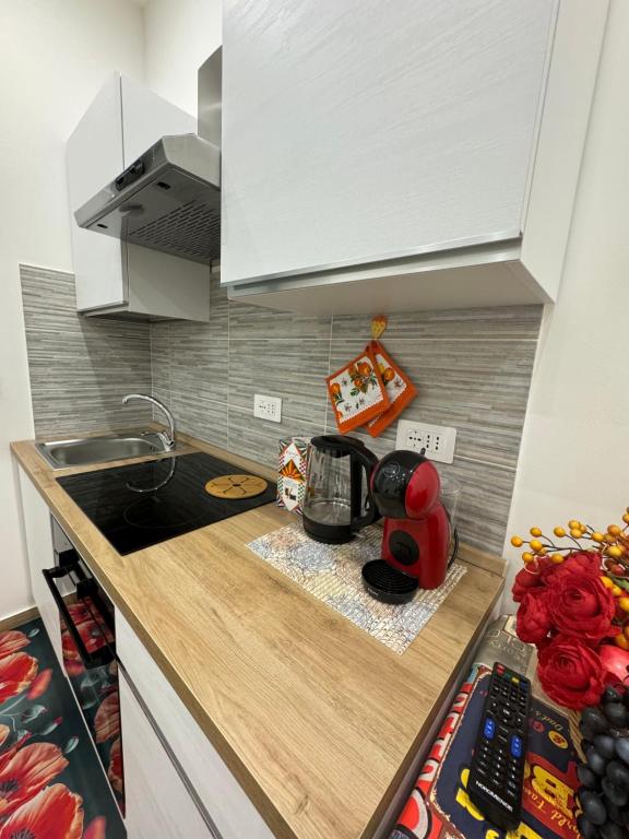 a kitchen with a counter top with a coffee maker at Il Tulipano house in Catania