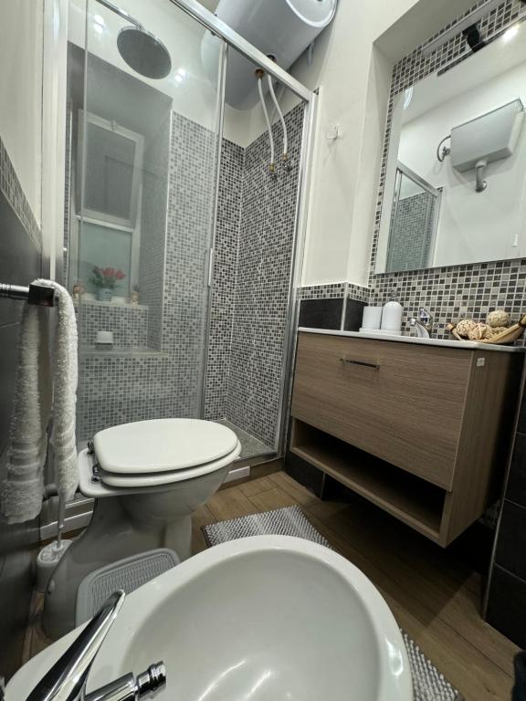 a bathroom with a toilet and a sink and a shower at Il Tulipano house in Catania