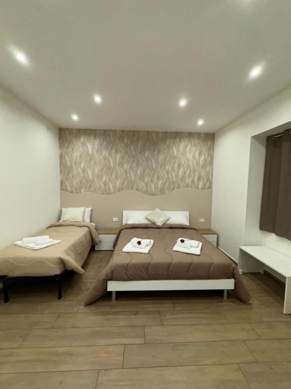 a bedroom with two beds in a room at Il Tulipano house in Catania