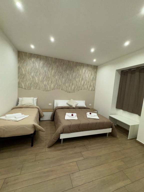 a bedroom with two beds in a room at Il Tulipano house in Catania