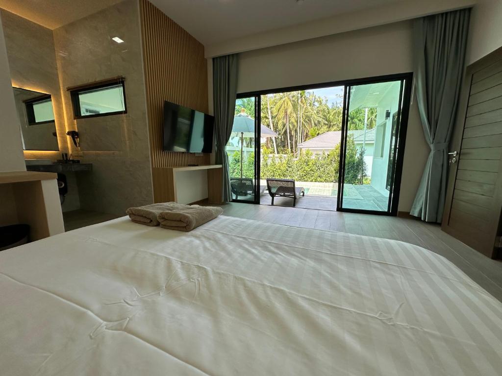 Postel nebo postele na pokoji v ubytování Aonang nine poolvilla resort