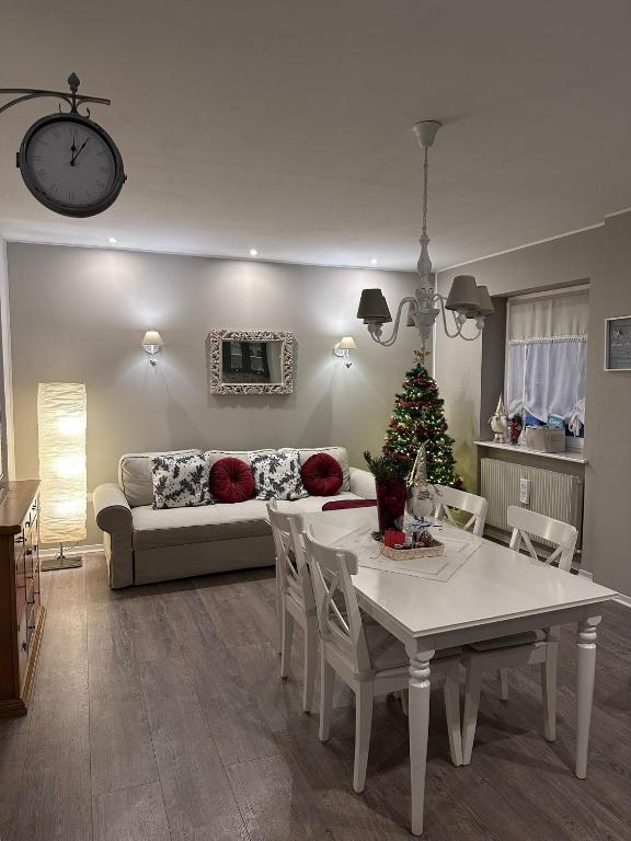 a living room with a table and a couch at A cjase di Luca in Paluzza