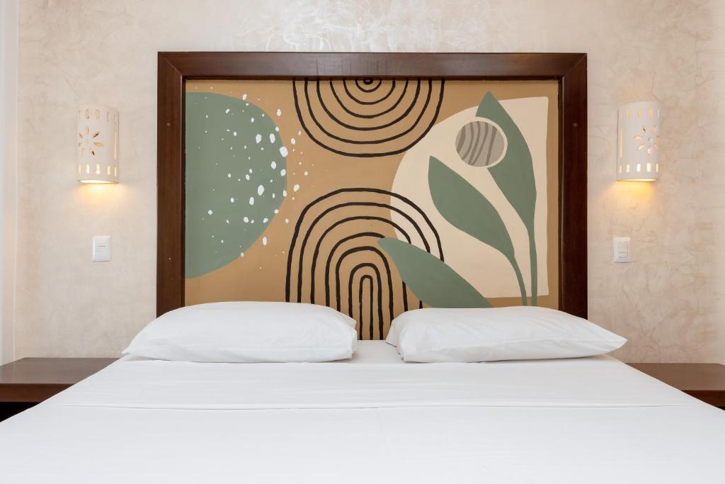 Cama ou camas em um quarto em Hotel Kinich